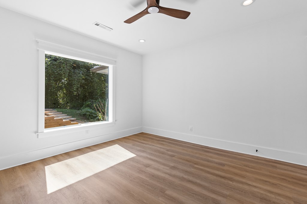 111 Highland Street Copperhill, TN 37317 - Photo 20 of 41 an empty room with wooden floor and windows