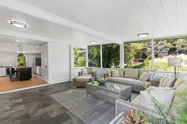 a living room with furniture and large windows