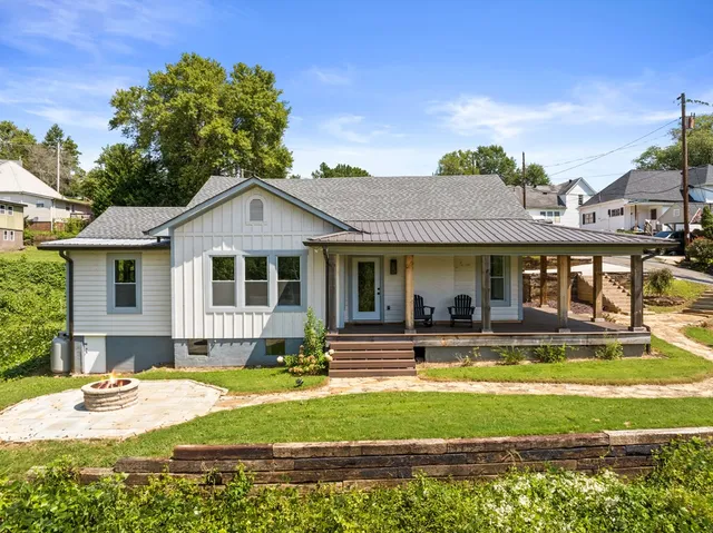 a view of a house with swimming pool and a yard