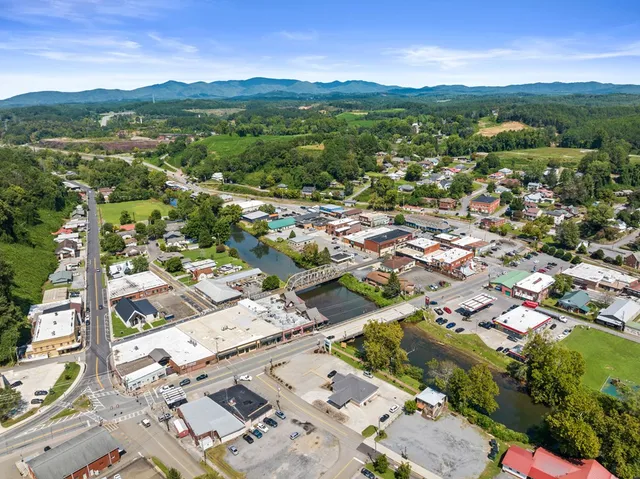 an aerial view of residential houses with outdoor space and river
