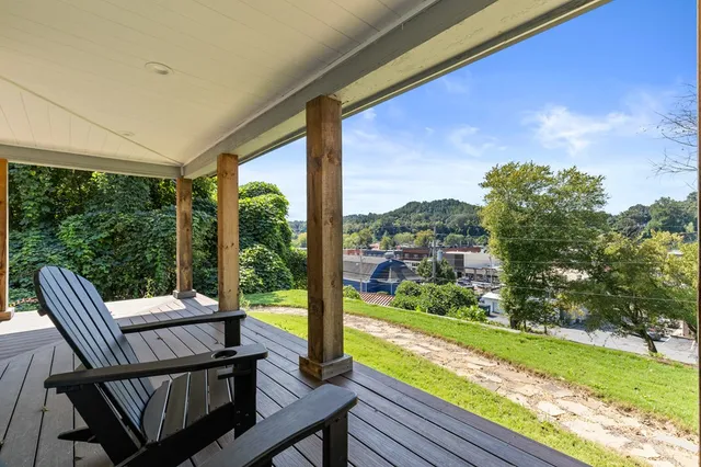 a view of a chairs and table in patio with a yard