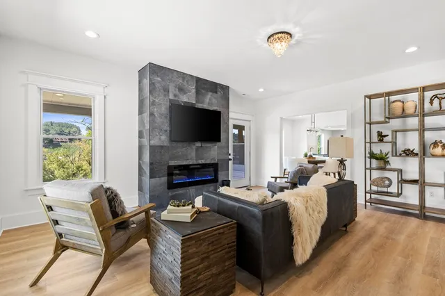 a living room with furniture a fireplace and a flat screen tv