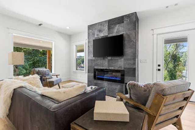 a living room with furniture fireplace and a flat screen tv