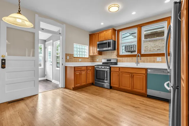 a kitchen with stainless steel appliances granite countertop a stove top oven sink and window