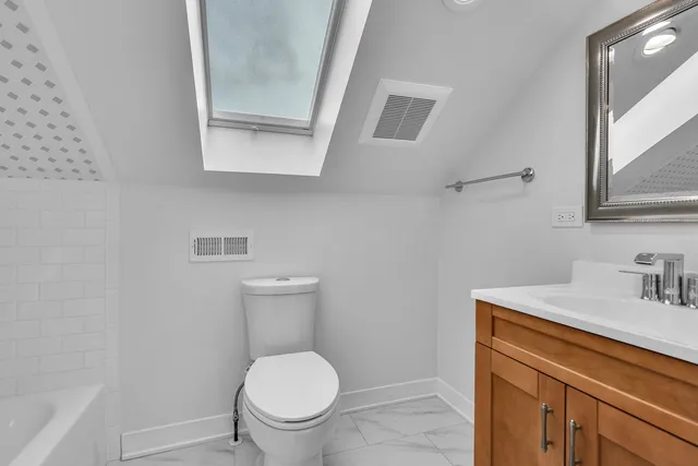 a bathroom with a sink toilet and vanity