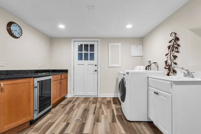 a utility room with cabinets washer and dryer