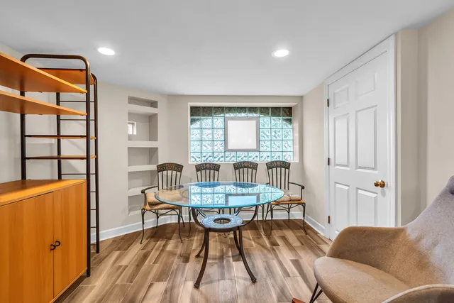 a living room with furniture a wooden floor and a window