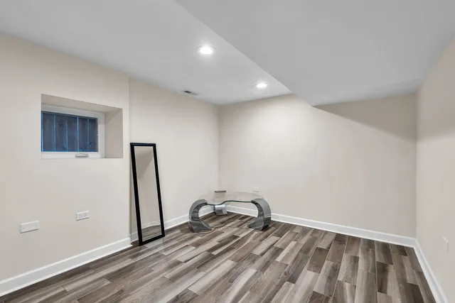 a view of a room with wooden floor