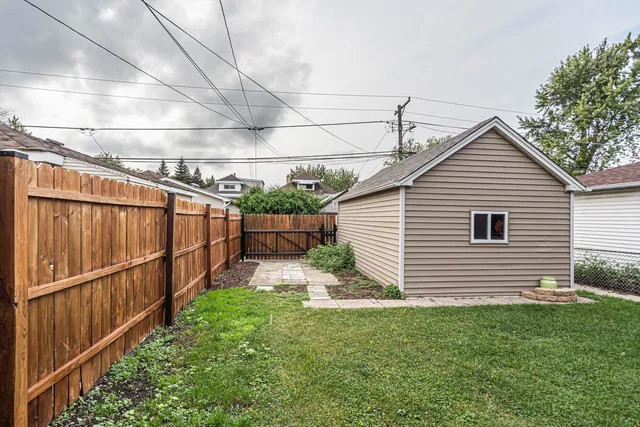 a view of a backyard with wooden fence