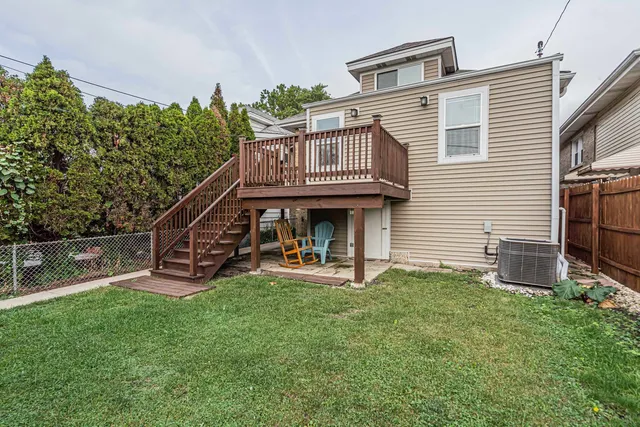 a view of a house with a yard and sitting area