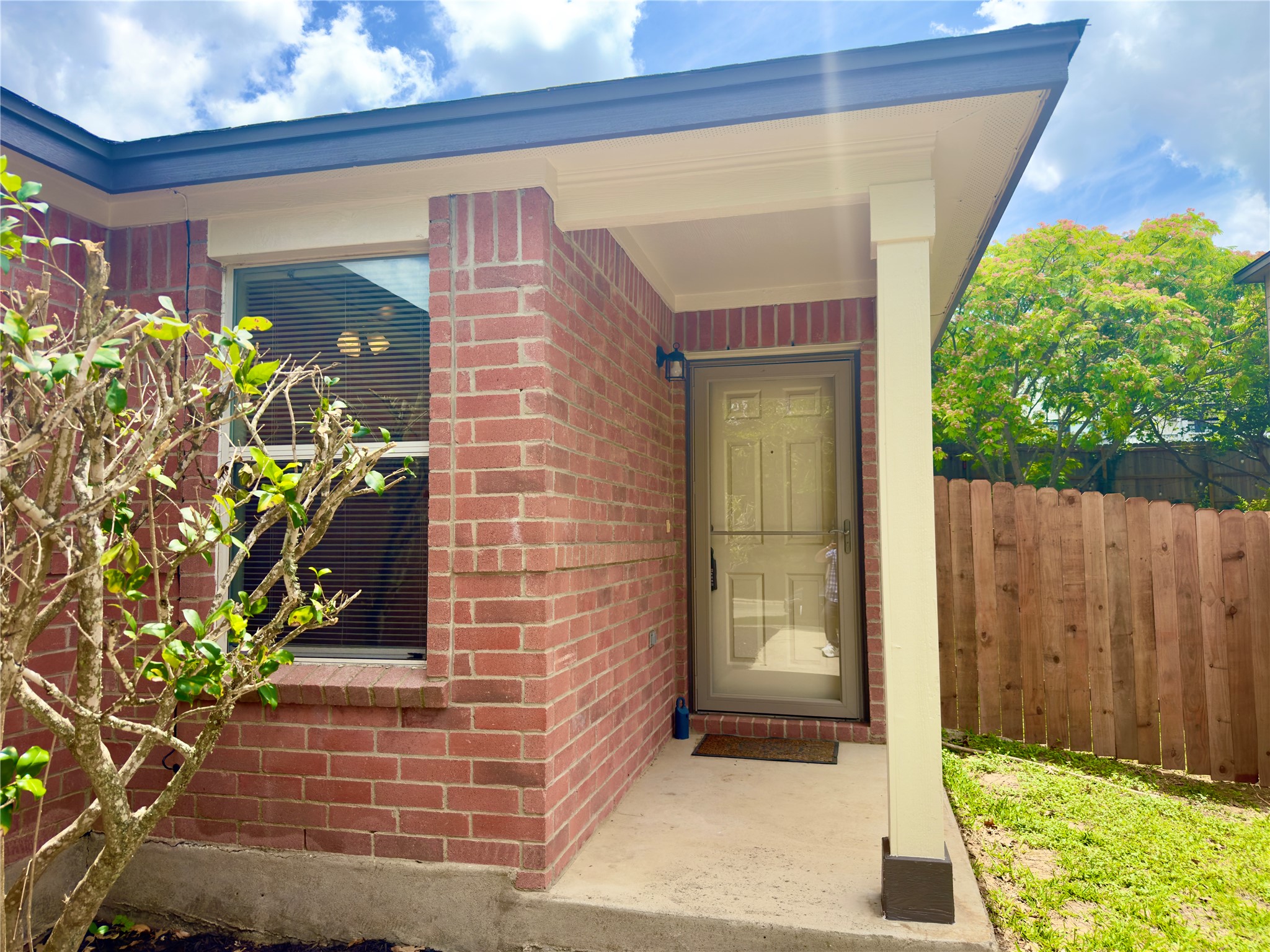 255 Myrtle Street Kyle, TX 78640 - Photo 2 of 31 Brick exterior with covered entryway and a light-colored entry door