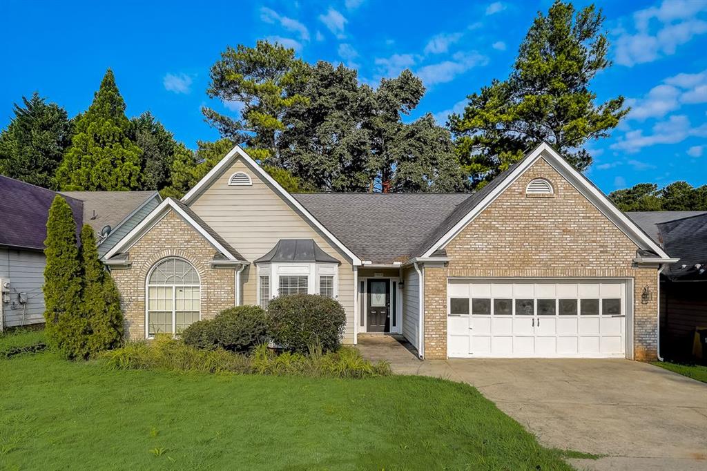3469 Ennfield Way Duluth, GA 30096 - Photo 1 of 1 a view of house with garden and tall trees