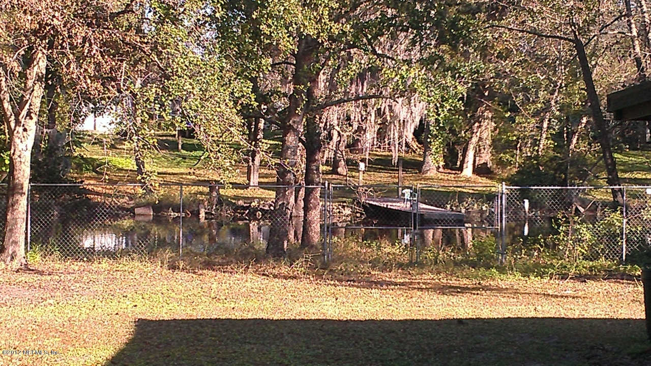 10587 Villanova Road Jacksonville, FL 32218 - Photo 1 of 13 a backyard of a house with table and chairs