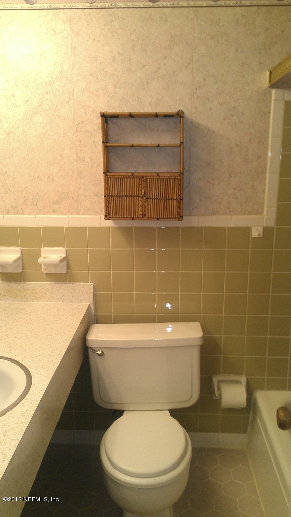 10587 Villanova Road Jacksonville, FL 32218 - Photo 11 of 13 a white toilet sitting next to a bathroom sink
