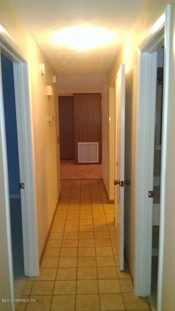 10587 Villanova Road Jacksonville, FL 32218 - Photo 12 of 13 a bathroom with a shower and a mirror