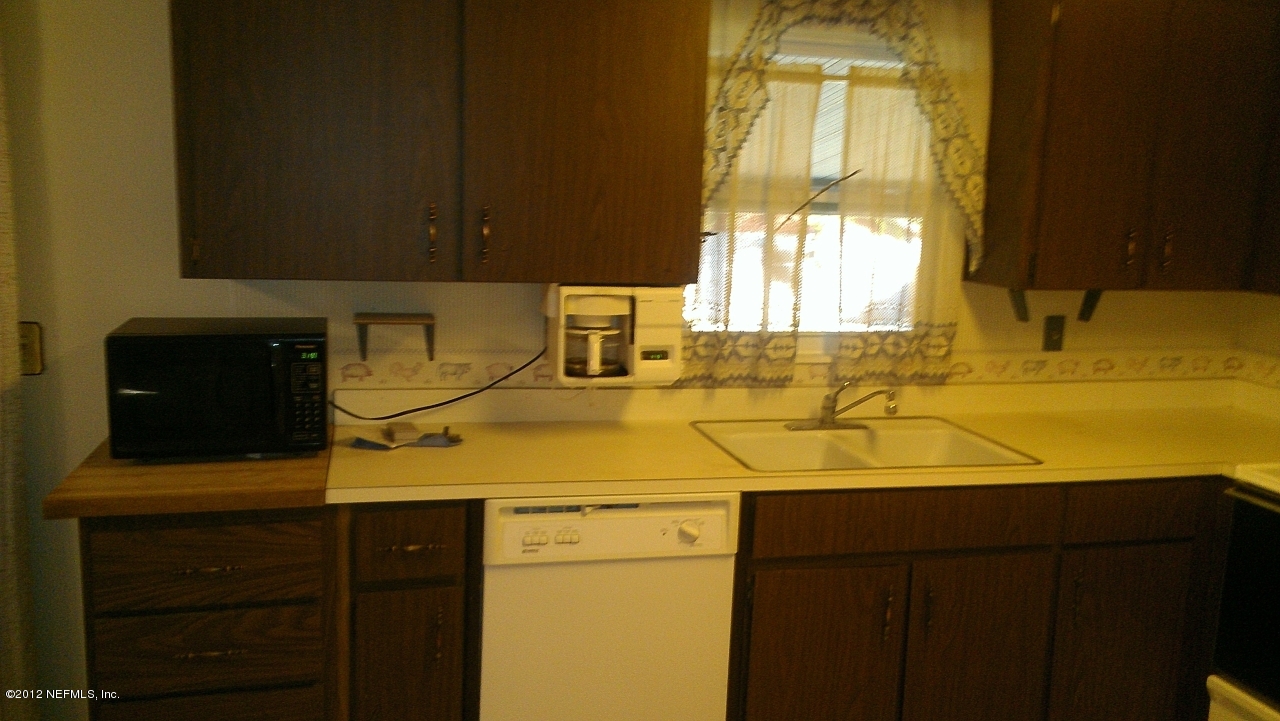 10587 Villanova Road Jacksonville, FL 32218 - Photo 10 of 13 a bathroom with a sink and a vanity