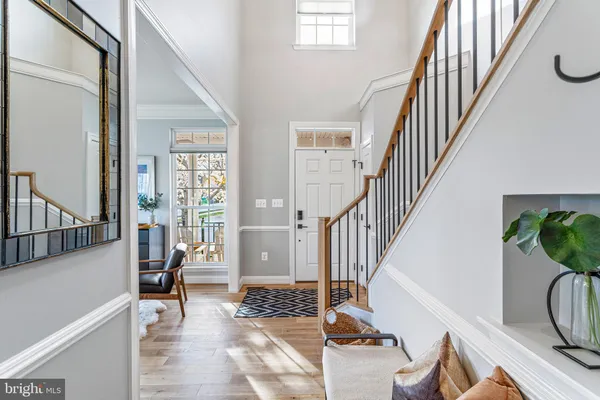 a kitchen with stainless steel appliances granite countertop a sink a stove and a wooden floors