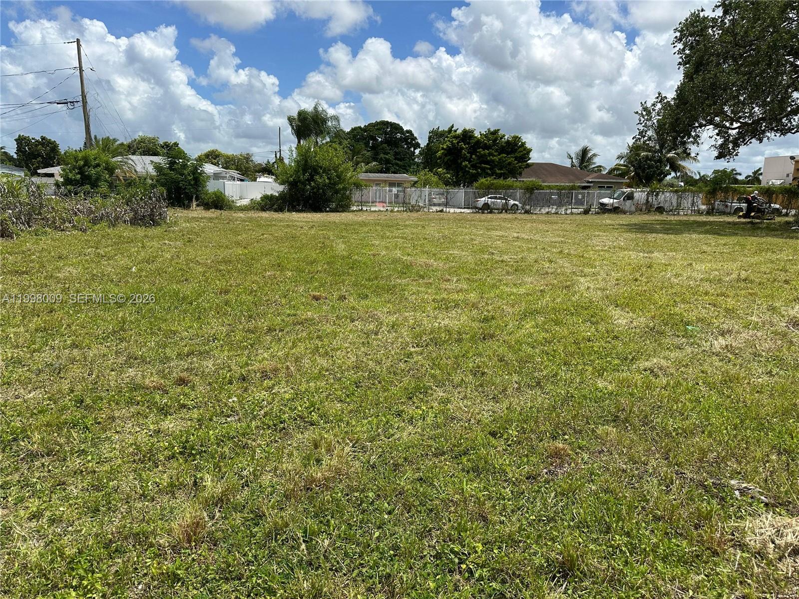 11888 Southwest 220th Street Miami, FL 33170 - Photo 7 of 8 a view of a large green field with lawn chairs