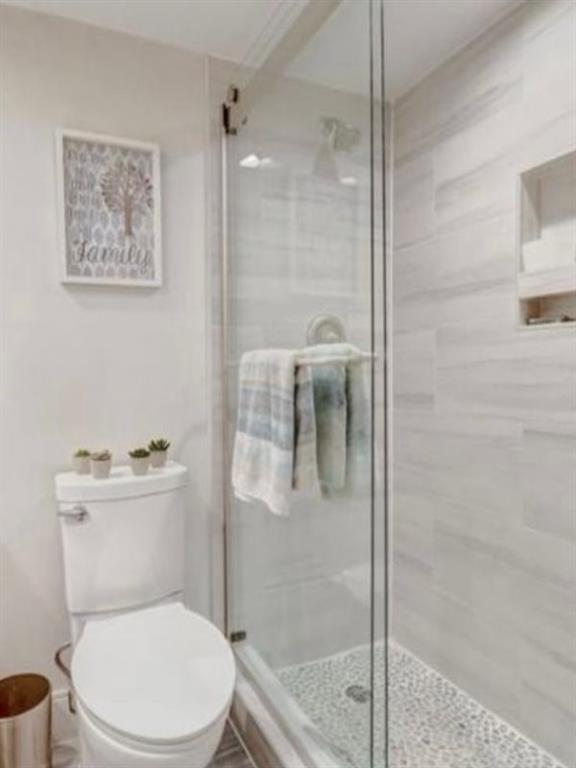 55 Southeast 14th Street, Unit 207 Boca Raton, FL 33432 - Photo 5 of 9 a white toilet sitting next to a bathroom sink