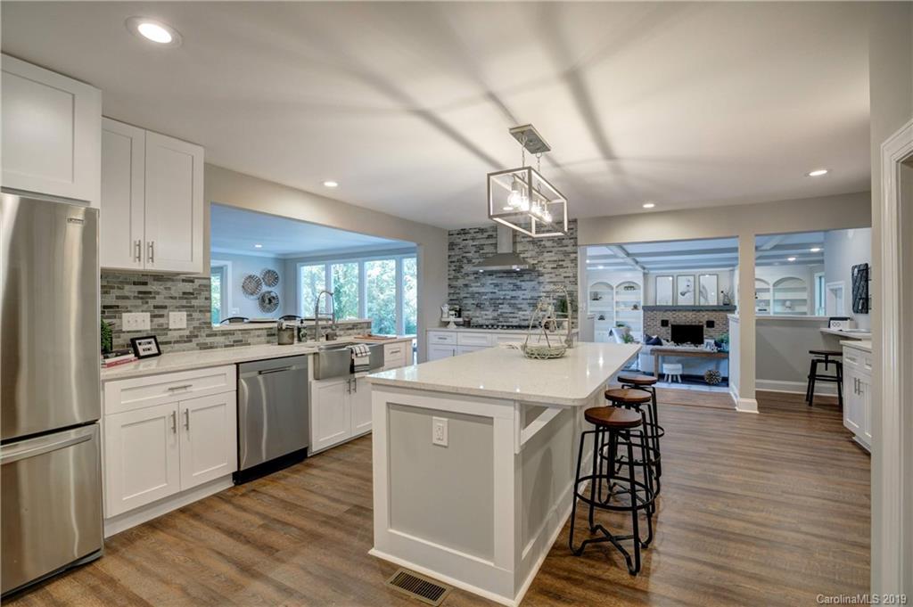 3811 High Ridge Road Charlotte, NC 28270 - Photo 5 of 35 a kitchen with stainless steel appliances granite countertop a sink dishwasher a refrigerator a stove a microwave oven with a dining table and chairs