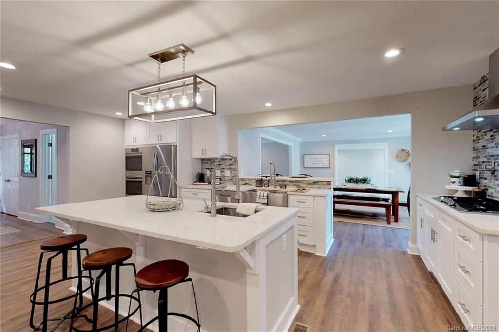 3811 High Ridge Road Charlotte, NC 28270 - Photo 6 of 35 a kitchen with a dining table chairs stainless steel appliances and cabinets