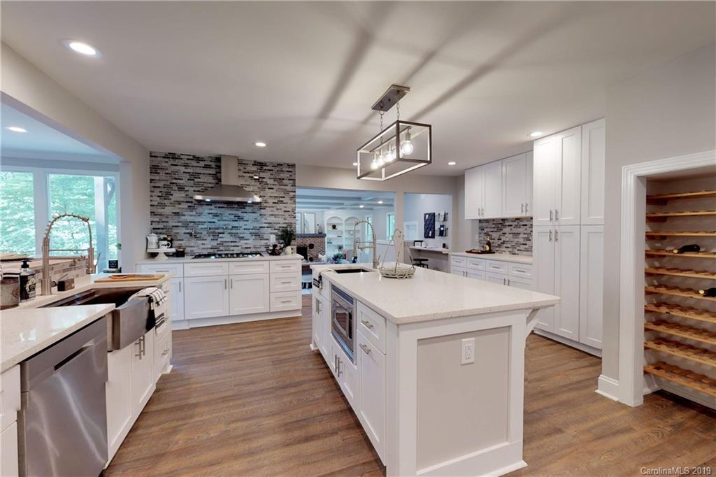 3811 High Ridge Road Charlotte, NC 28270 - Photo 8 of 35 a kitchen with stainless steel appliances a sink counter space cabinets and a center