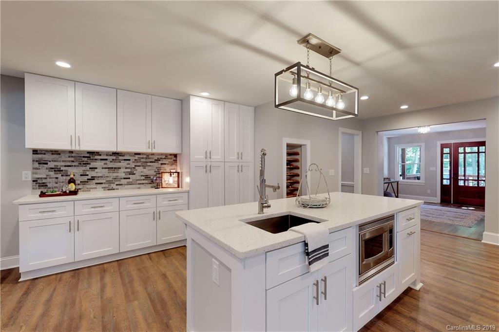 3811 High Ridge Road Charlotte, NC 28270 - Photo 9 of 35 a kitchen that has a lot of white cabinets and stainless steel appliances