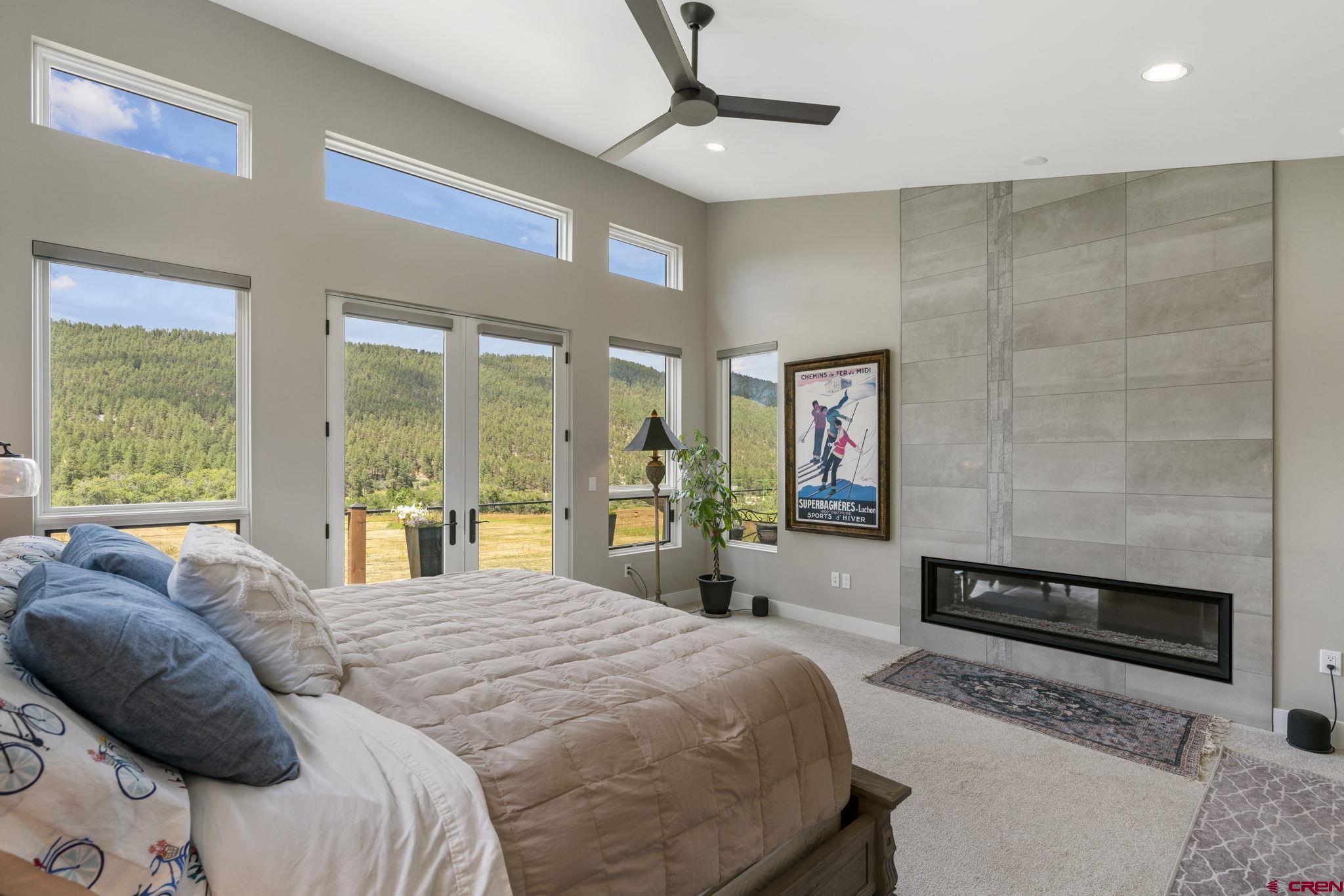 1212 Sunrise Lane Durango, CO 81301 - Photo 14 of 35 a bedroom with a bed and a large window