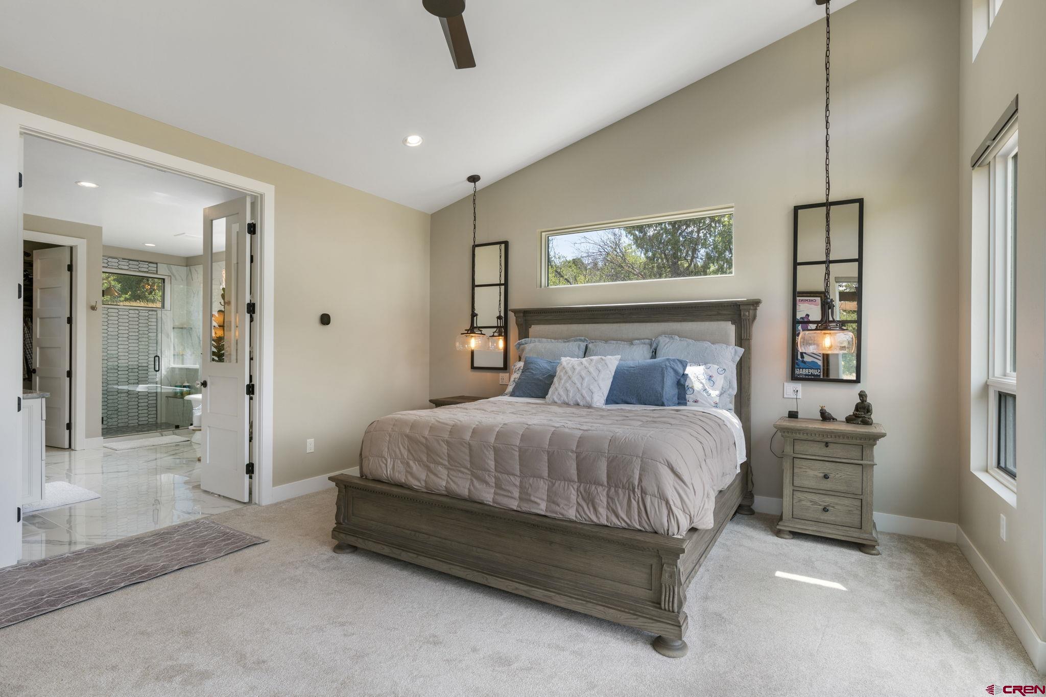 1212 Sunrise Lane Durango, CO 81301 - Photo 15 of 35 a spacious bedroom with a bed and glass windows