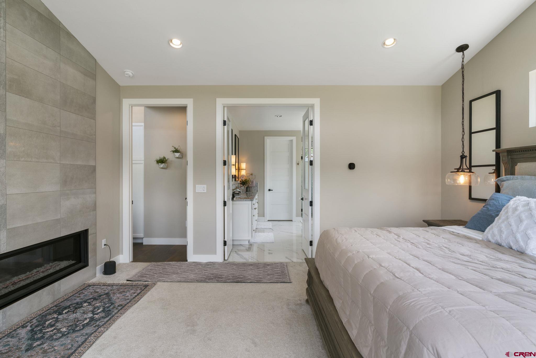 1212 Sunrise Lane Durango, CO 81301 - Photo 16 of 35 a bedroom with a bed and a fireplace