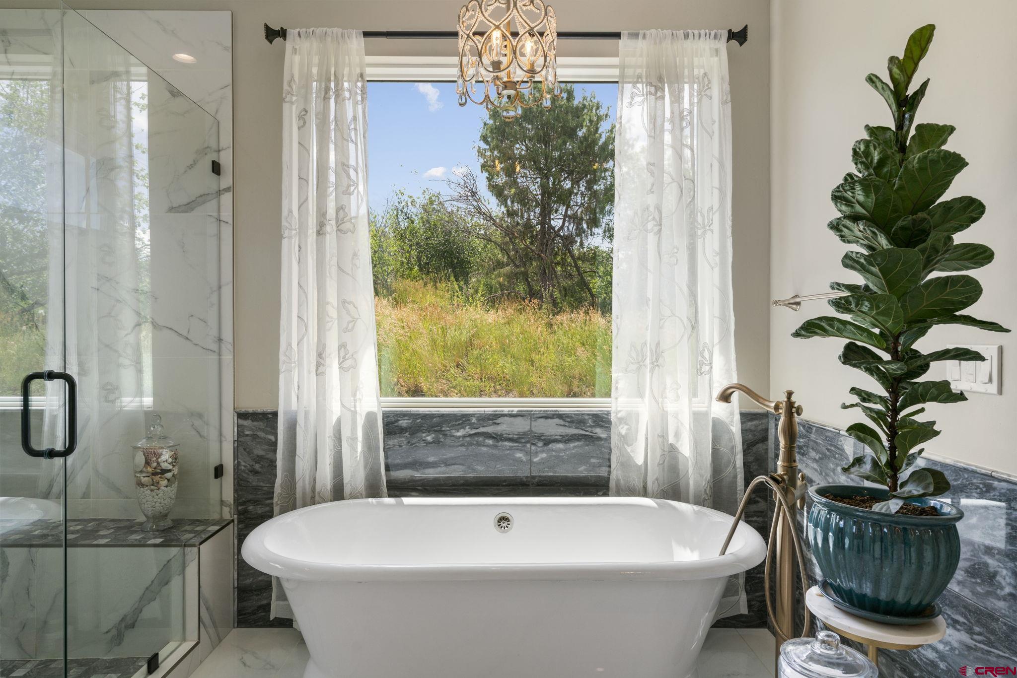 1212 Sunrise Lane Durango, CO 81301 - Photo 18 of 35 a bath tub sitting in a bathroom next to a window