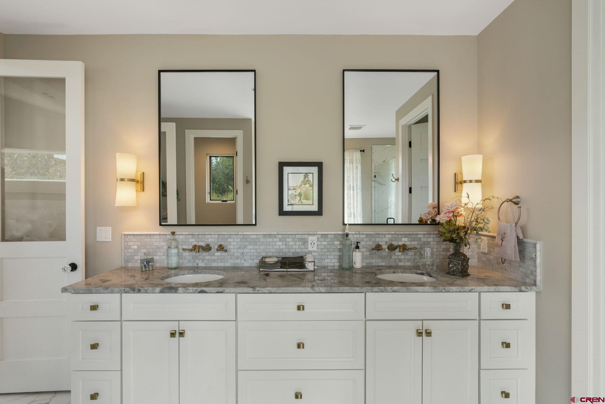 1212 Sunrise Lane Durango, CO 81301 - Photo 19 of 35 a bathroom with double sink and a mirror