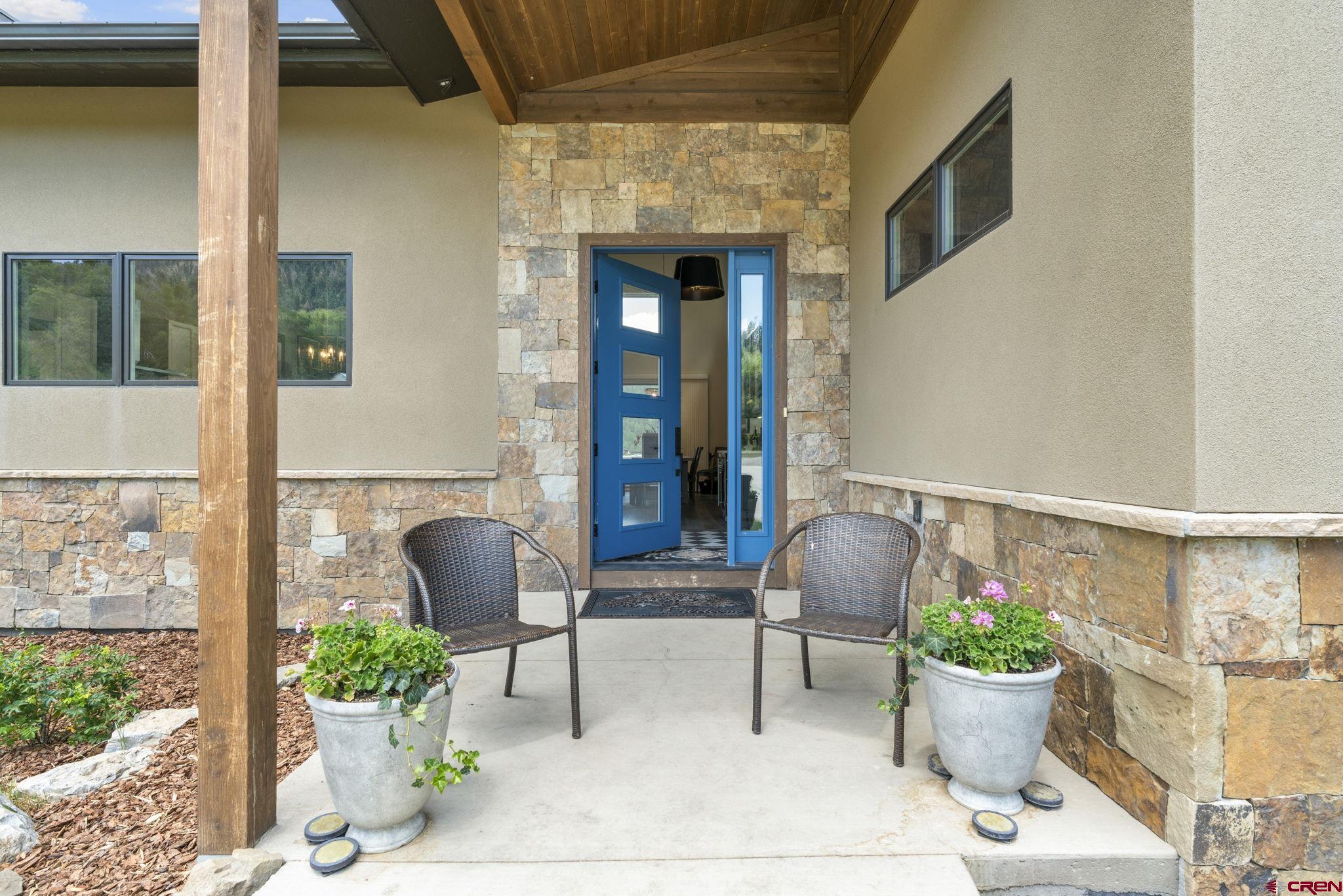 1212 Sunrise Lane Durango, CO 81301 - Photo 2 of 35 a view of a patio with chair and potted plants