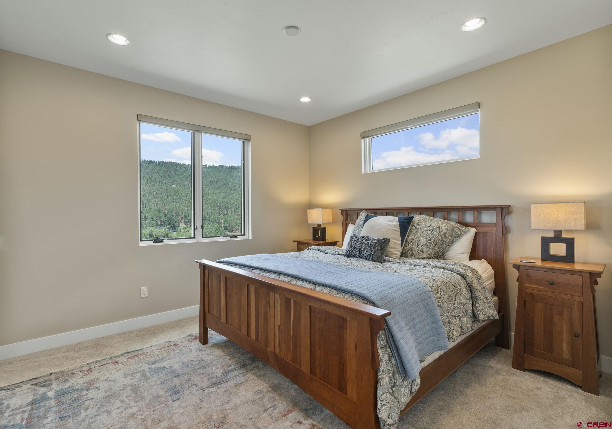 1212 Sunrise Lane Durango, CO 81301 - Photo 21 of 35 a bed sitting in a bedroom next to a window