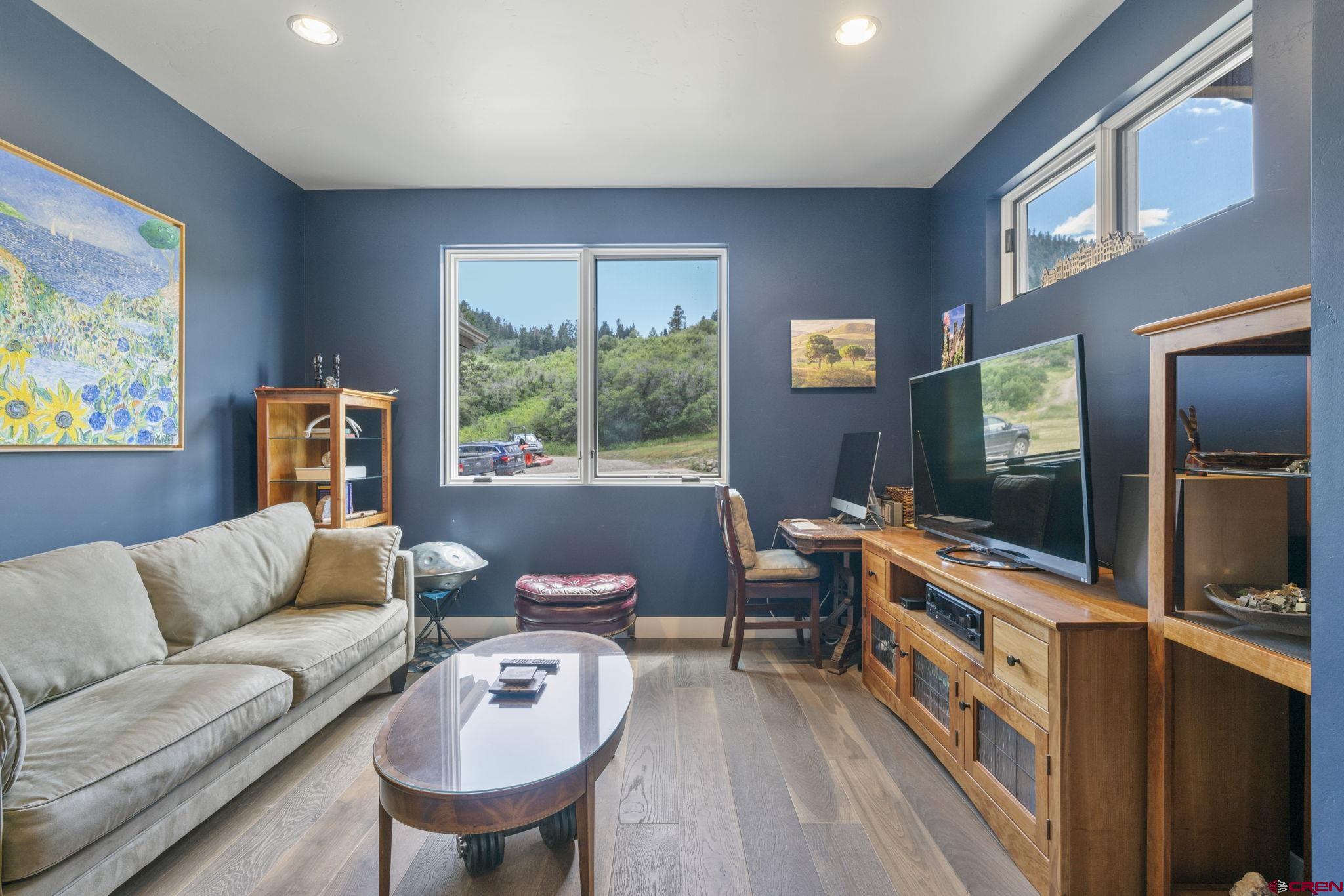 1212 Sunrise Lane Durango, CO 81301 - Photo 24 of 35 a living room with furniture and a flat screen tv
