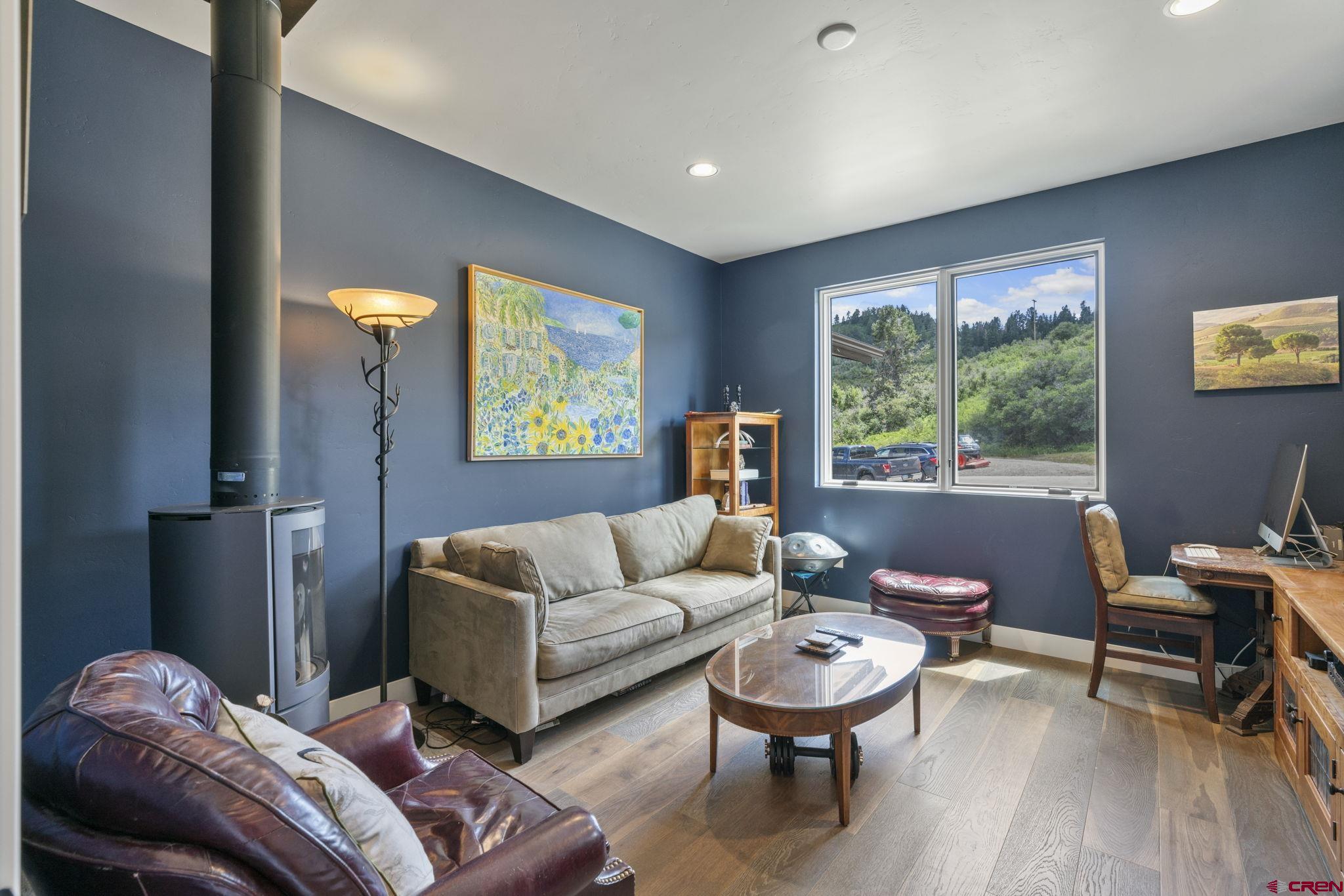 1212 Sunrise Lane Durango, CO 81301 - Photo 25 of 35 a living room with furniture and a wooden floor