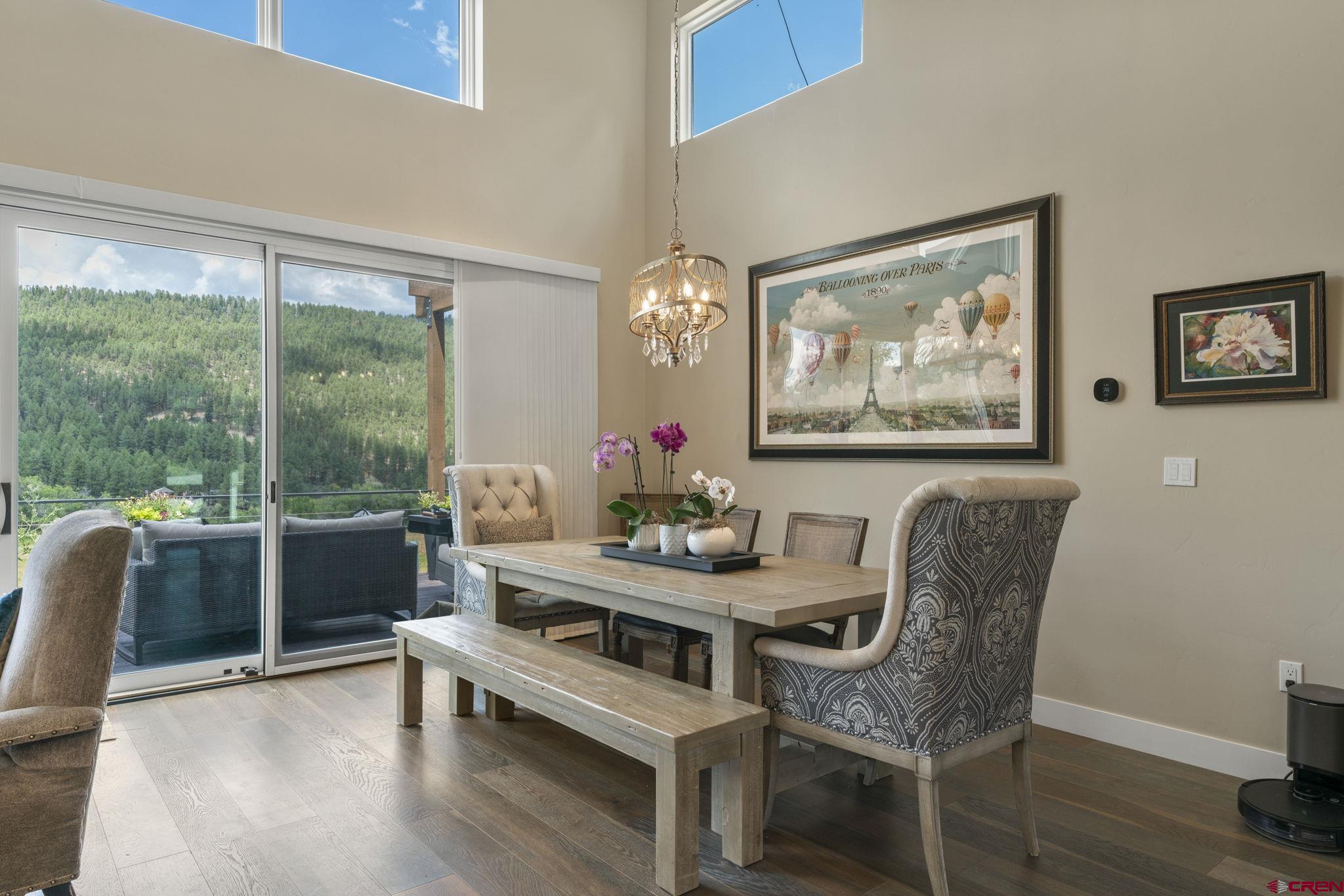 1212 Sunrise Lane Durango, CO 81301 - Photo 8 of 35 a dining room with furniture a large window and wooden floor