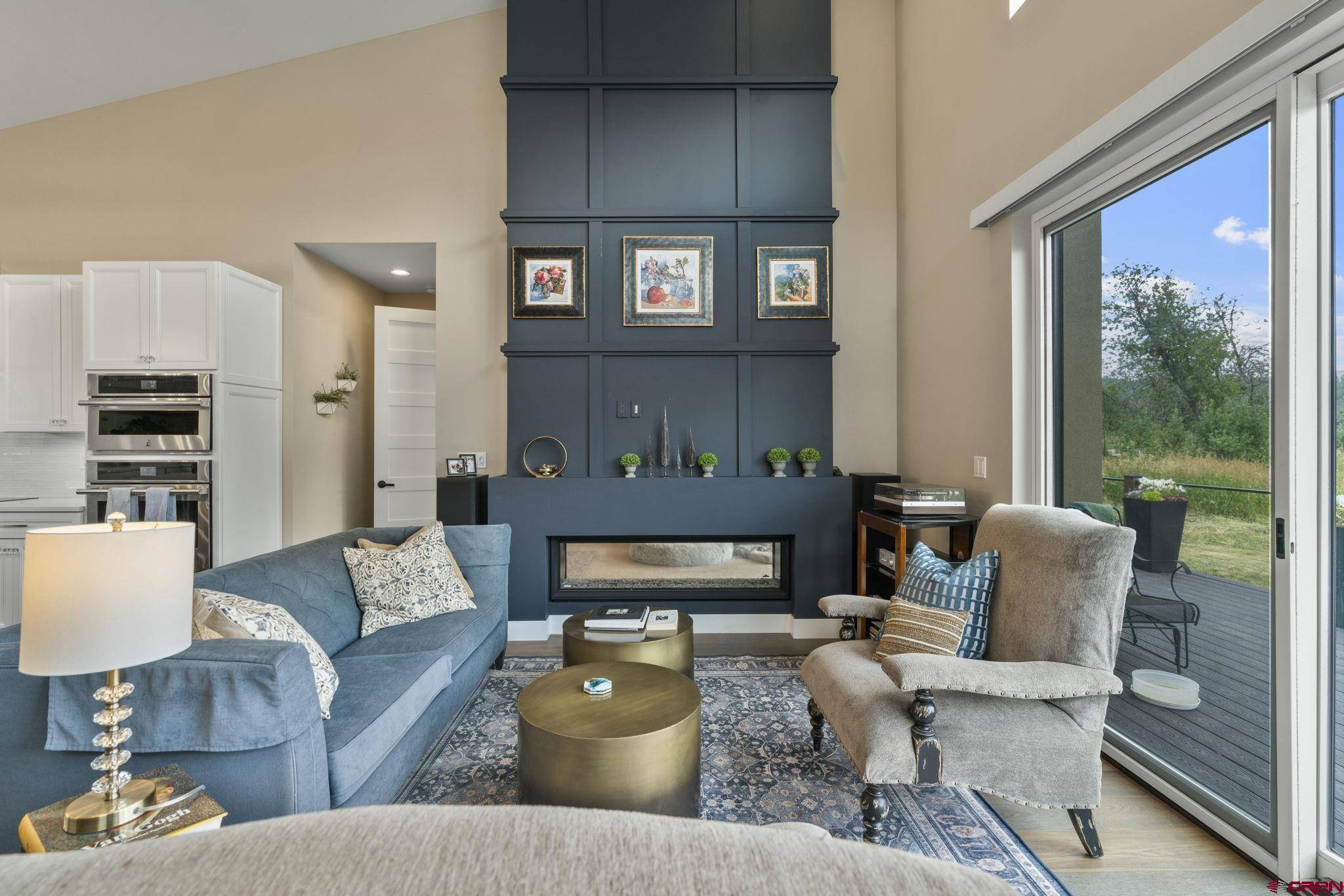 1212 Sunrise Lane Durango, CO 81301 - Photo 9 of 35 a living room with furniture fireplace and a large window