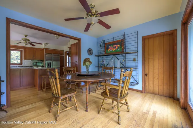 a view of a dining room with furniture and a chandelier