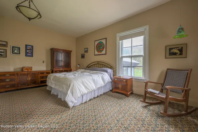 a bedroom with a bed and chair