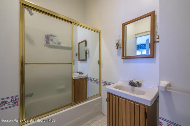 a bathroom with a sink and mirror