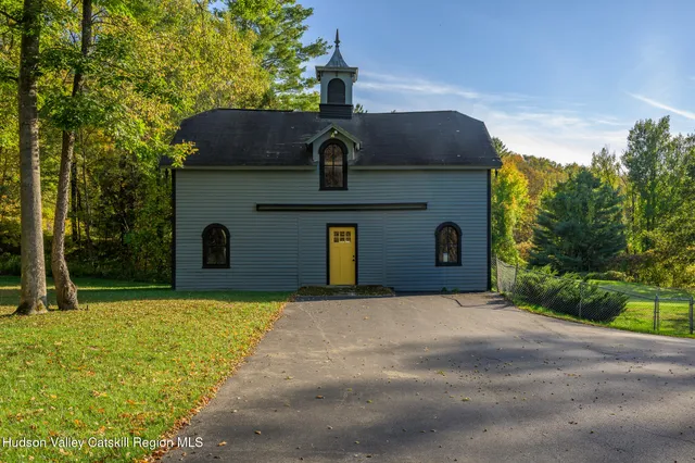 a front view of a building with a garden