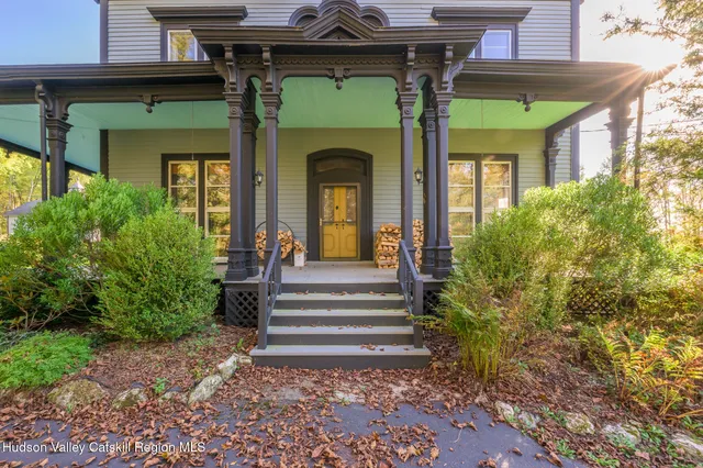 a front view of a house with plants