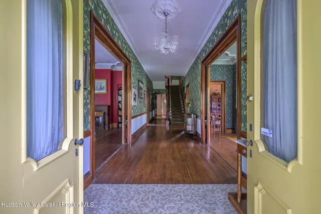 a hallway with wooden floor and furniture