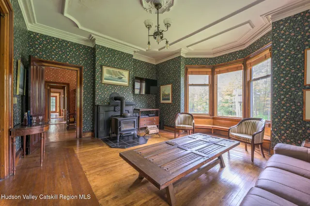 a living room with furniture a table and a large window
