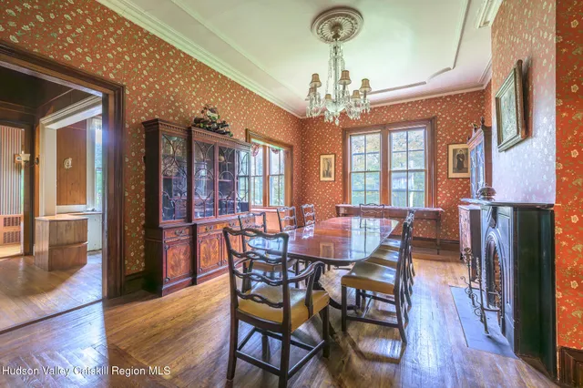 a view of a dining room with furniture wooden floor and chandelier