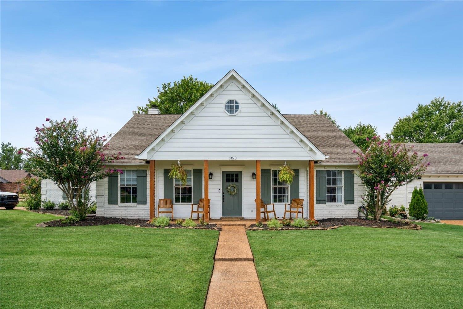 1423 Howling Drive Collierville, TN 38017 - Photo 1 of 28 View of front facade featuring a garage, a front lawn, and covered porch