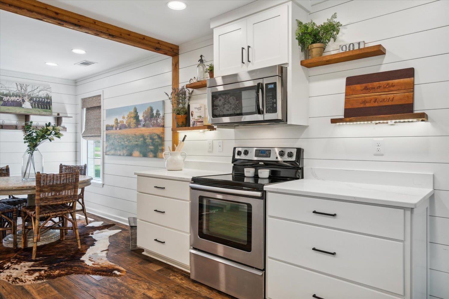 1423 Howling Drive Collierville, TN 38017 - Photo 11 of 28 Kitchen with appliances with stainless steel finishes, beamed ceiling, dark wood-type flooring, and white cabinets