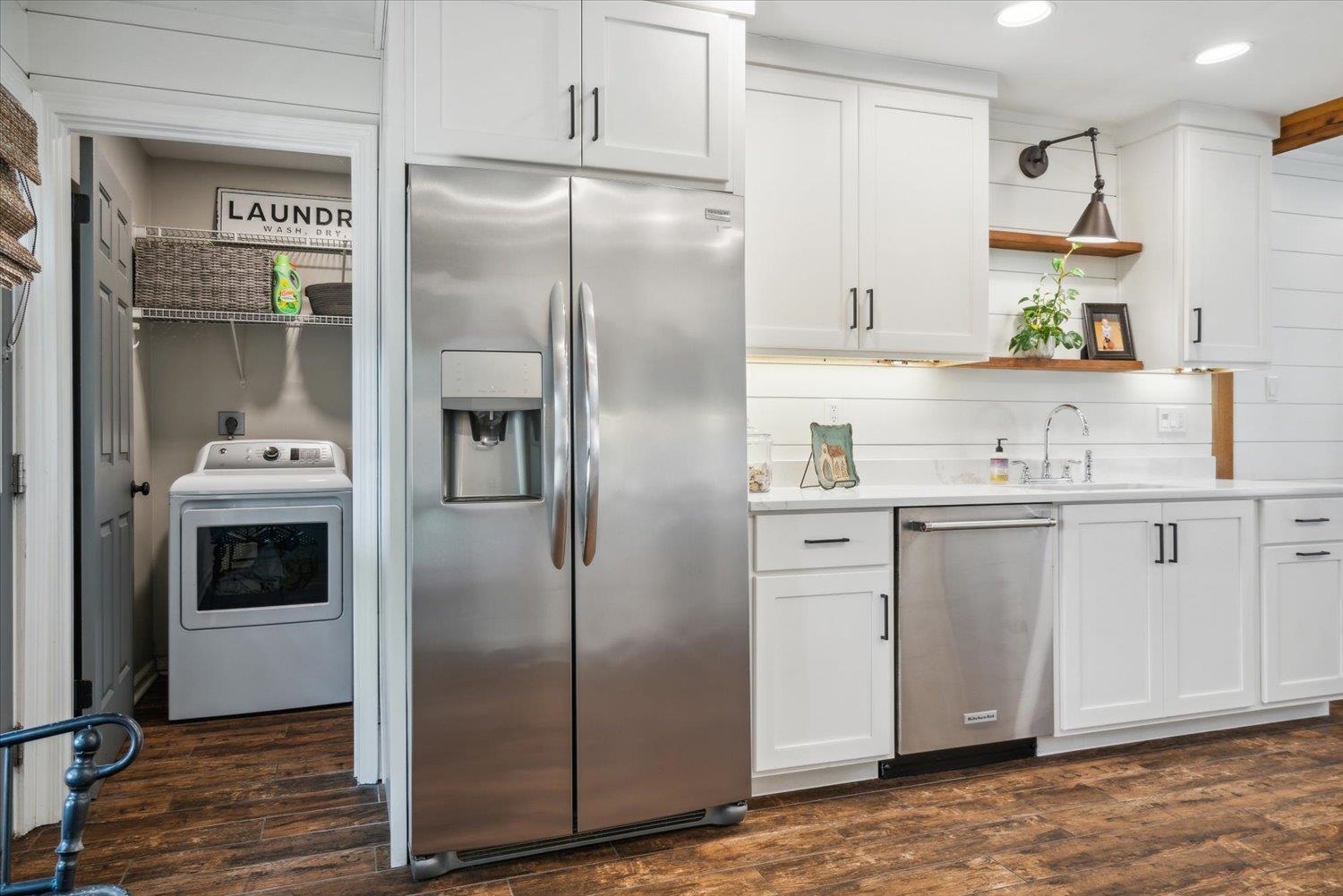 1423 Howling Drive Collierville, TN 38017 - Photo 13 of 28 Kitchen featuring washer / dryer, white cabinetry, dark hardwood / wood-style flooring, and stainless steel appliances