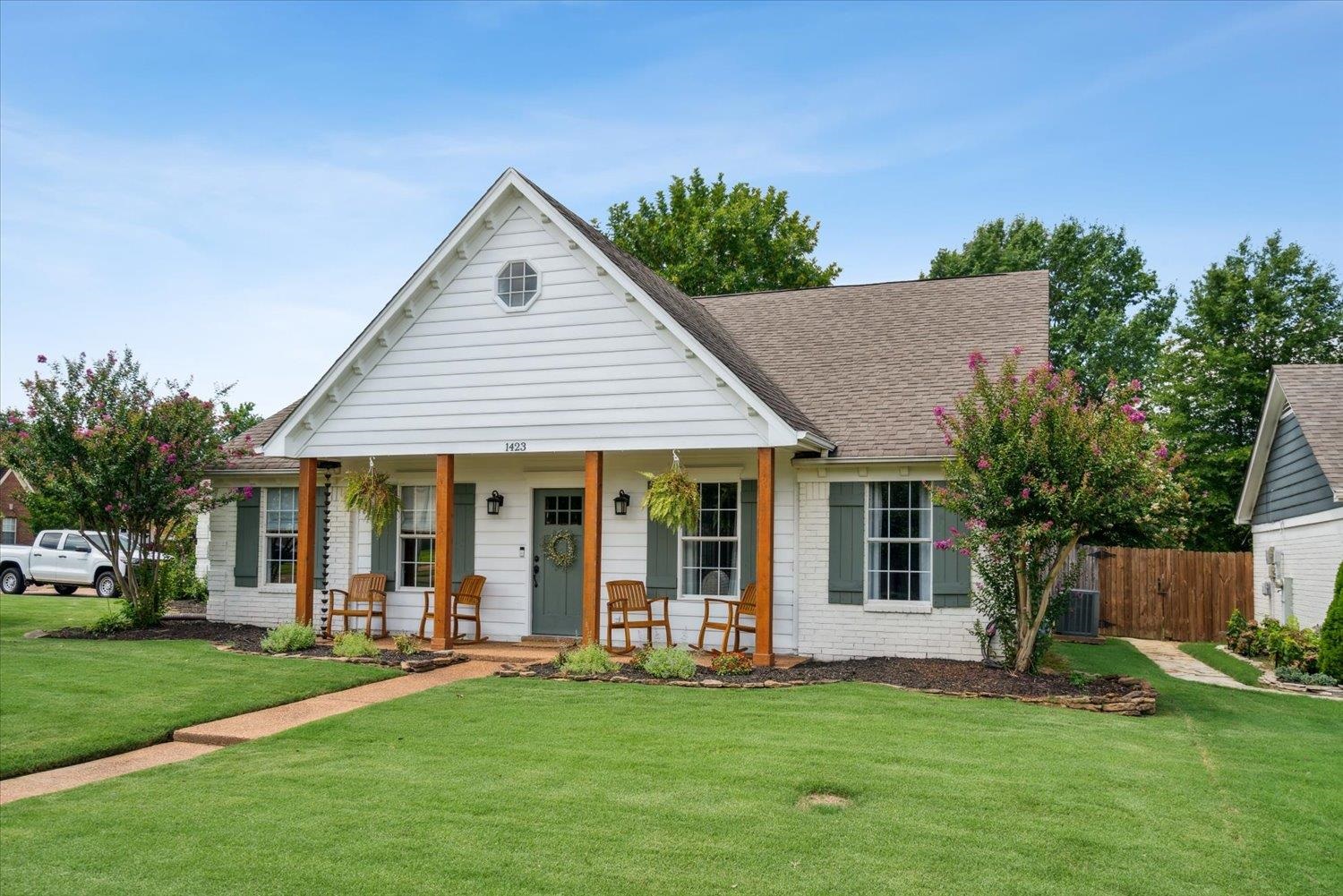 1423 Howling Drive Collierville, TN 38017 - Photo 2 of 28 View of front of property featuring a porch, central air condition unit, and a front yard